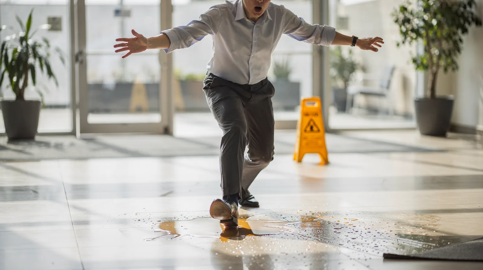 Icy, snow-covered walkway posing a slip risk outside a building